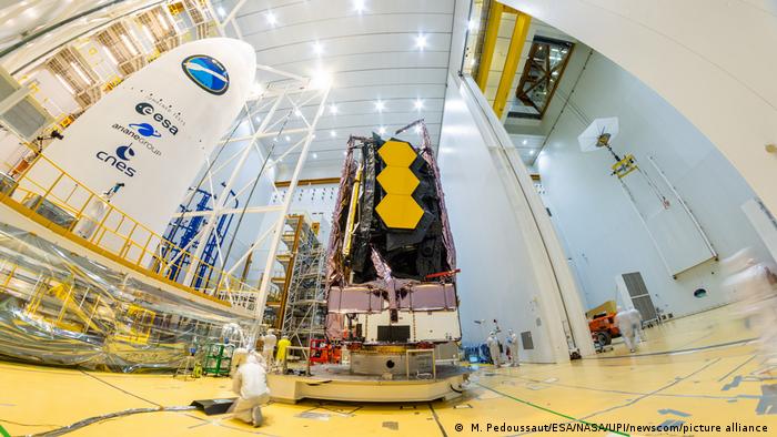 The James Webb Space Telescope prior to its launch from French Guiana in December 2021. In this photo technicians are working on the telescope.